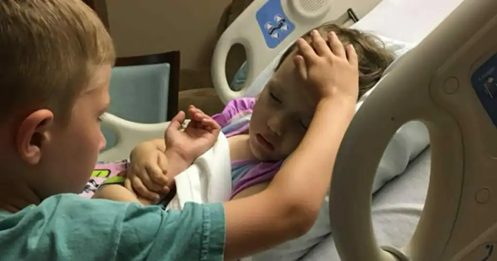 The story behind a heartbreaking image of a 6-year-old boy saying goodbye to his dying sister